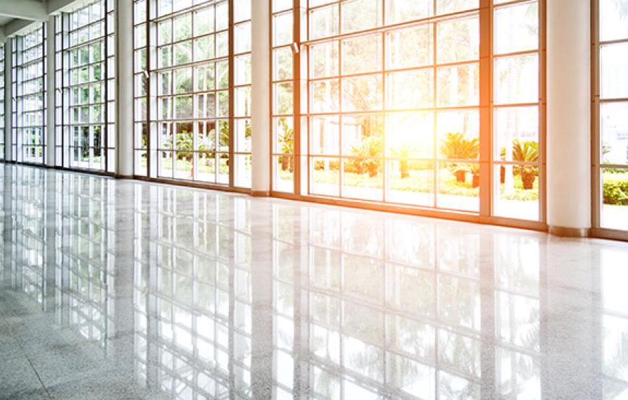 Empty lobby with glass windows and sun coming through